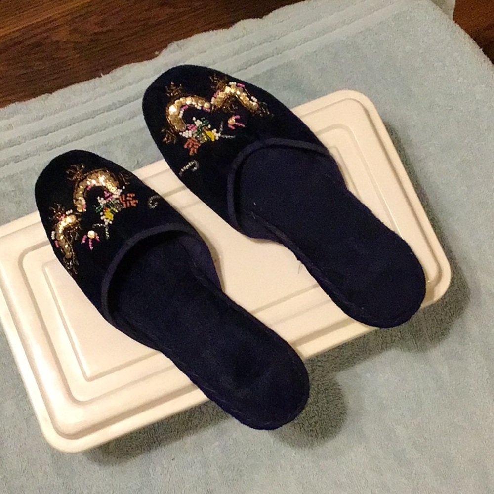 Black Slippers with beaded detailing.